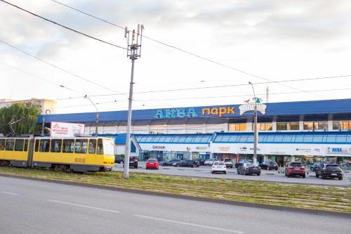 a yellow train is parked in front of a shopping center at VIP Квартира на Науковій, аквапарк in Lviv