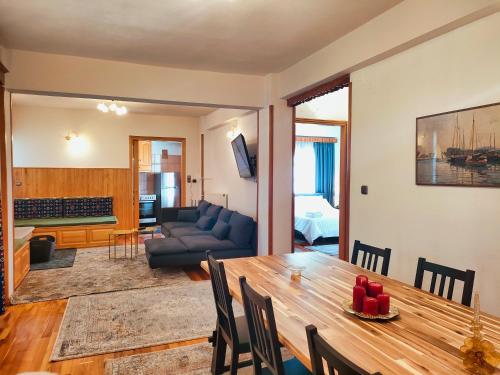 a living room with a table and a couch at Majestic Vista Residence in Metsovo