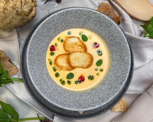 a plate of food with biscuits in a yellow sauce at U HRÁDKU Superior in Znojmo