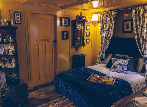 a bedroom with a bed with a tray of food on it at Sheddington Manor - 2 Bedroom Guest House & Cinema in Belfast
