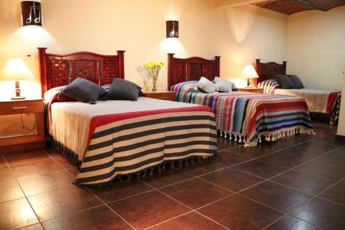 a hotel room with two beds in a room at Hotel Castillo Santa Cecilia in Tapalpa