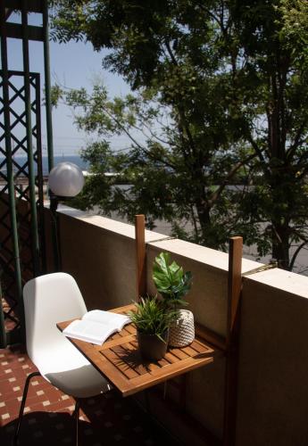 a small table and a chair on a balcony at Mirage Place B&B in Catania