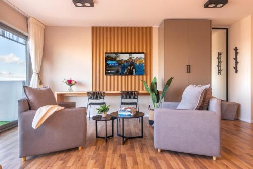 a living room with two couches and a table at Trendy Apartment in Puerto Madero in Buenos Aires