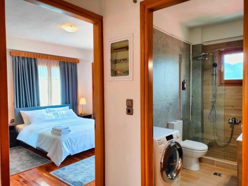 a bedroom with a bed and a shower at Majestic Vista Residence in Metsovo