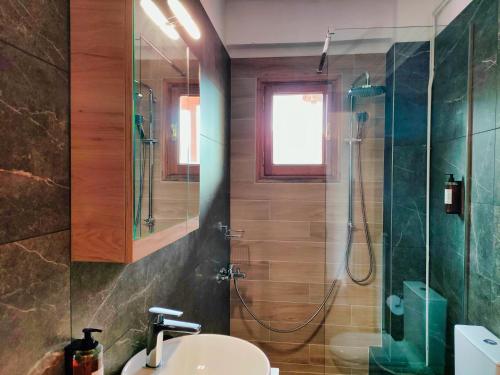 a bathroom with a sink and a shower at Majestic Vista Residence in Metsovo