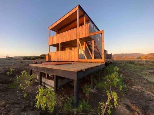 a house sitting on top of a wooden platform at Buchuvillas Surf House in Buchupureo