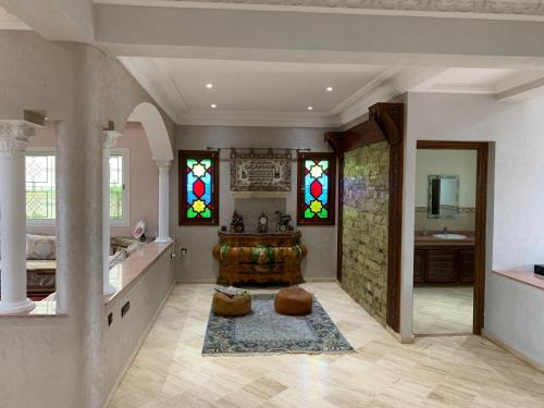 a bathroom with a tub and stained glass windows at Villa Belle Plage Dar Bouazza in Casablanca