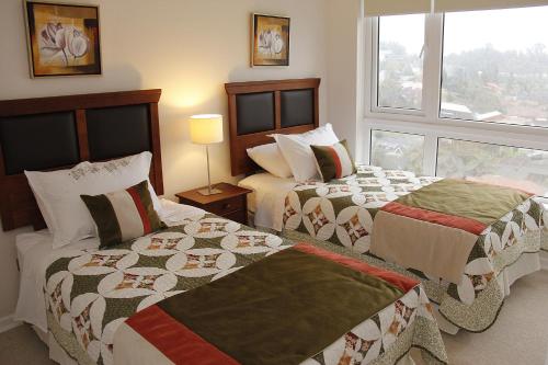 מיטה או מיטות בחדר ב-Concepción Suites