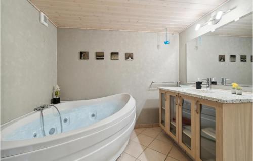 a bathroom with a large tub and two sinks at Stunning Home In Esbjerg V With Kitchen in Esbjerg