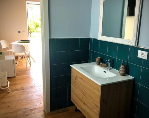 a bathroom with a sink and a mirror and a table at STRAPALU' in Fondi