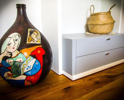 a large vase sitting on the floor next to a dresser at STRAPALU' in Fondi