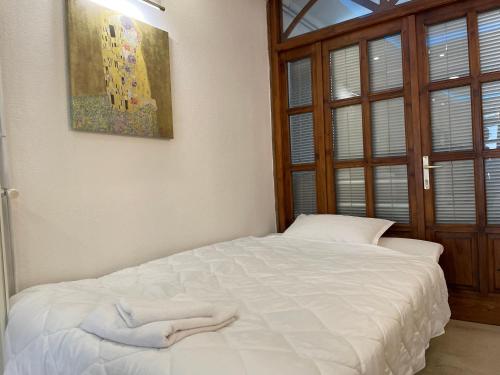 a bedroom with a white bed with towels on it at Bora Apartmani - FREE PARKING - CITY CENTER in Vranje