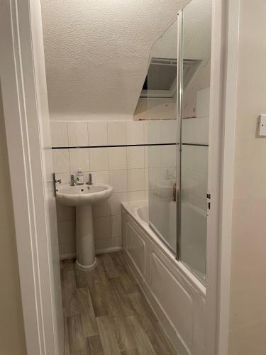 uma casa de banho com um lavatório e um chuveiro em Cozy Private Room in a Beautiful Accommodation close to Orpington em Foots Cray