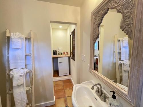 a bathroom with a sink and a mirror at Casa Culinaria - The Gourmet Inn in Santa Fe