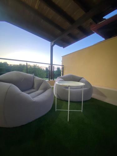 a living room with two white couches and a table at Villa Beauty in Paliouri