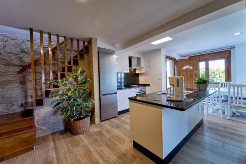 a kitchen with a large island with a counter top at O Lar de Lola in Mondariz