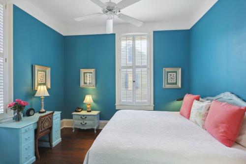 a blue bedroom with a bed and a ceiling fan at Maison Perrier Bed & Breakfast in New Orleans