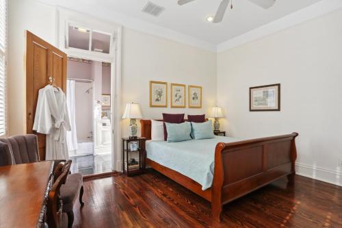 a bedroom with a bed and a table in a room at Maison Perrier Bed & Breakfast in New Orleans