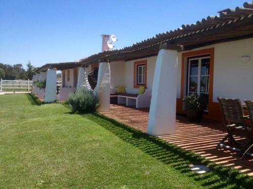 a backyard of a house with a wooden deck at SeteQuintas in Zambujeira do Mar