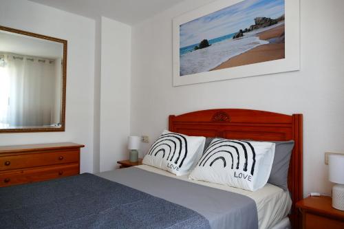 a bedroom with a bed with two white pillows at NABILA9 in Torrevieja