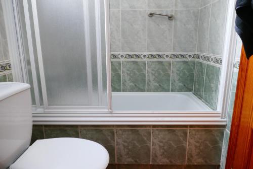 a bathroom with a shower and a white toilet at NABILA9 in Torrevieja