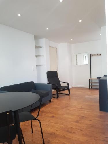 a living room with two chairs and a couch at Appartement T4 des jardins in Chambéry