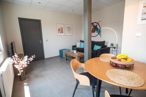 a living room with a table with a bowl of fruit on it at Luxury Apartment in Chalkida #1 in Chalkida