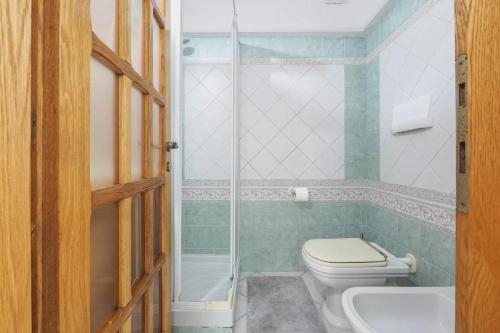 a bathroom with a toilet and a shower and a sink at Saint Simplicio House in Olbia