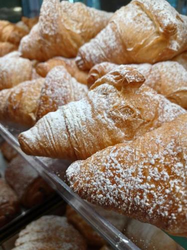 a bunch of pastries with powdered sugar on them at STRAPALU' in Fondi