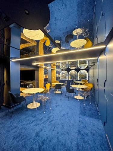 a dining room with tables and chairs and lights at Grand Hotel Santa Ana in Cuenca