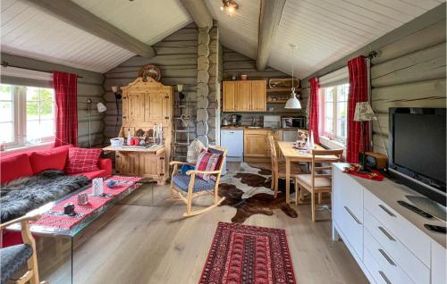 a living room with a red couch and a table at Stunning Home In Nord-torpa With Kitchen in Nord Torpa