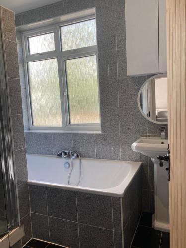 a bathroom with a sink and a window at Highfield Home with free parkings, Surbiton, Kingston upon Thames, Surrey, Greater London , UK in Surbiton