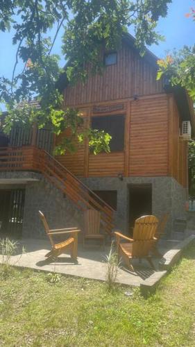 a house with two chairs and a staircase at Vila Vera in Vršac