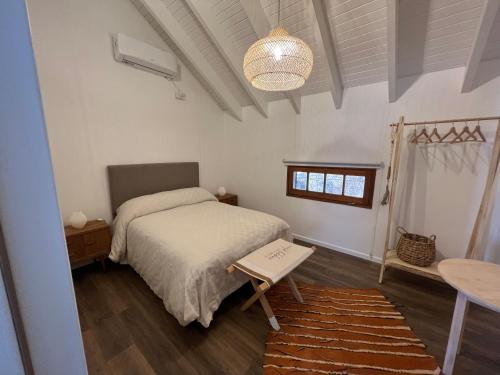 a bedroom with a bed and a table and a lamp at Oeste suites in Mendoza