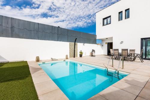 a swimming pool in the backyard of a house at Ocean House Torre del Mar in Torre del Mar