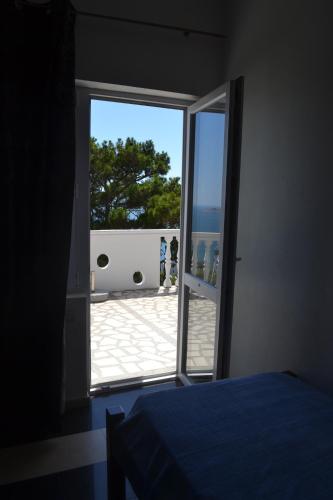 a bedroom with a door open to a patio at Holiday house Ogi in Bar