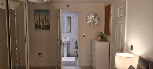 a room with a hallway with a clock on the wall at Cross River in Durham