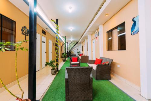a corridor of a hospital with chairs and tables at Hospedaje Mary in Paracas