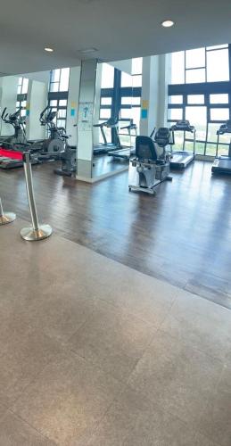a gym with several treadmills and chairs in a room at RS Homestay in Seri Kembangan