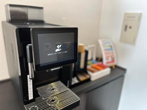 a computer monitor sitting on top of a desk at Court Hotel Fukuoka Tenjin in Fukuoka