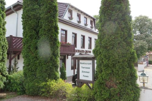 a sign in front of a building between two trees at Rhodaer Grund in Erfurt
