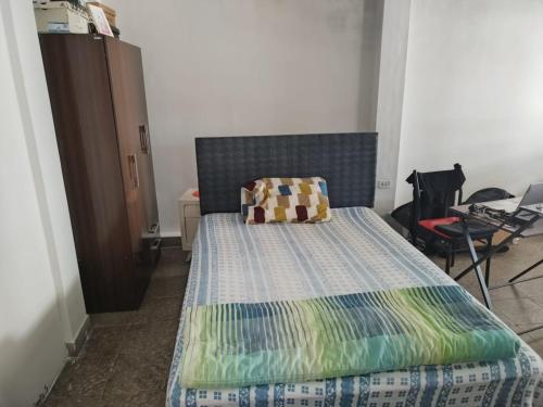 a bedroom with a bed with a quilt on it at Piura Eterno Calor in Piura