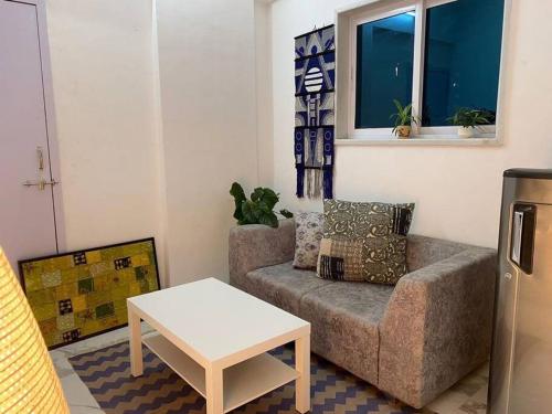 a living room with a couch and a table at Angel Views 601, Chapel Road, Bandra West by Connekt Homes in Mumbai