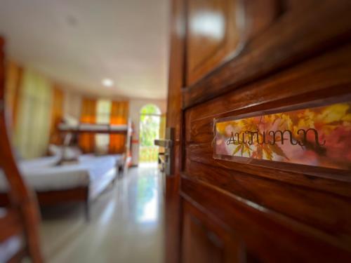 a door in a room with a bed and a bedroom at White Summerville Tourist Inn in Busuanga