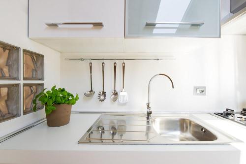 una cocina con fregadero de acero inoxidable y fregadero en Apartment 23, en Como