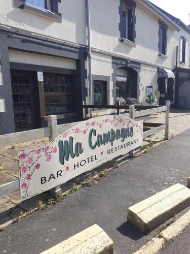 a sign on the side of a road in front of a building at Ma Campagne - Le Jardin in Auberville