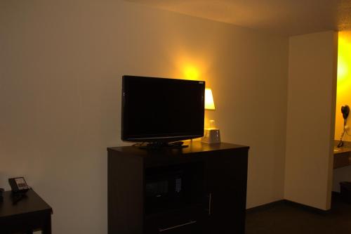 a television sitting on top of a dresser in a room at Super 8 by Wyndham Colby in Colby