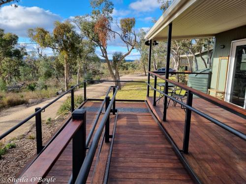 a porch of a house with benches on it at Glen Lough Cabins in Glen Aplin