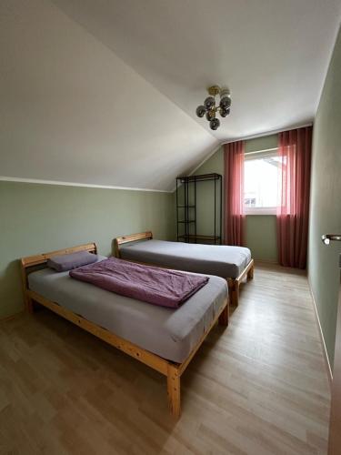 a bedroom with two beds and a window at Felicidad in Löchgau