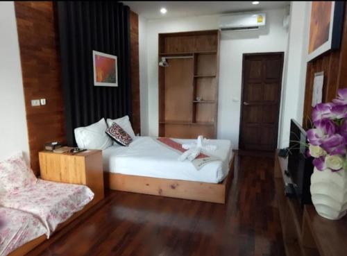 a small room with a bed and a cabinet at Pai Woodland Resort in Pai